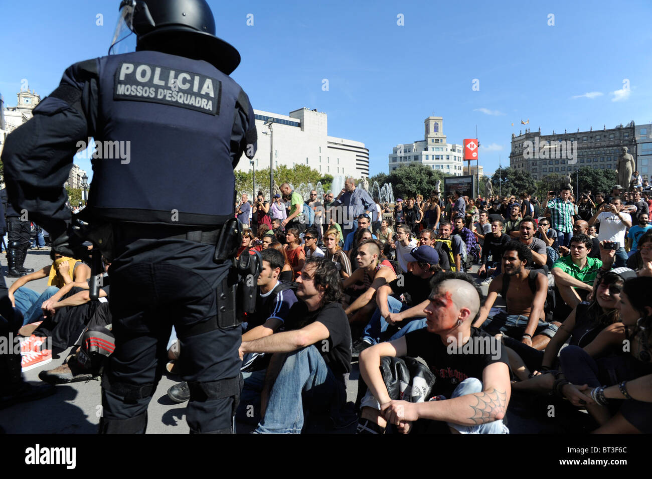 Riot police monitor demonstrators against system in the clashes at the city centre during the general strike . Stock Photo