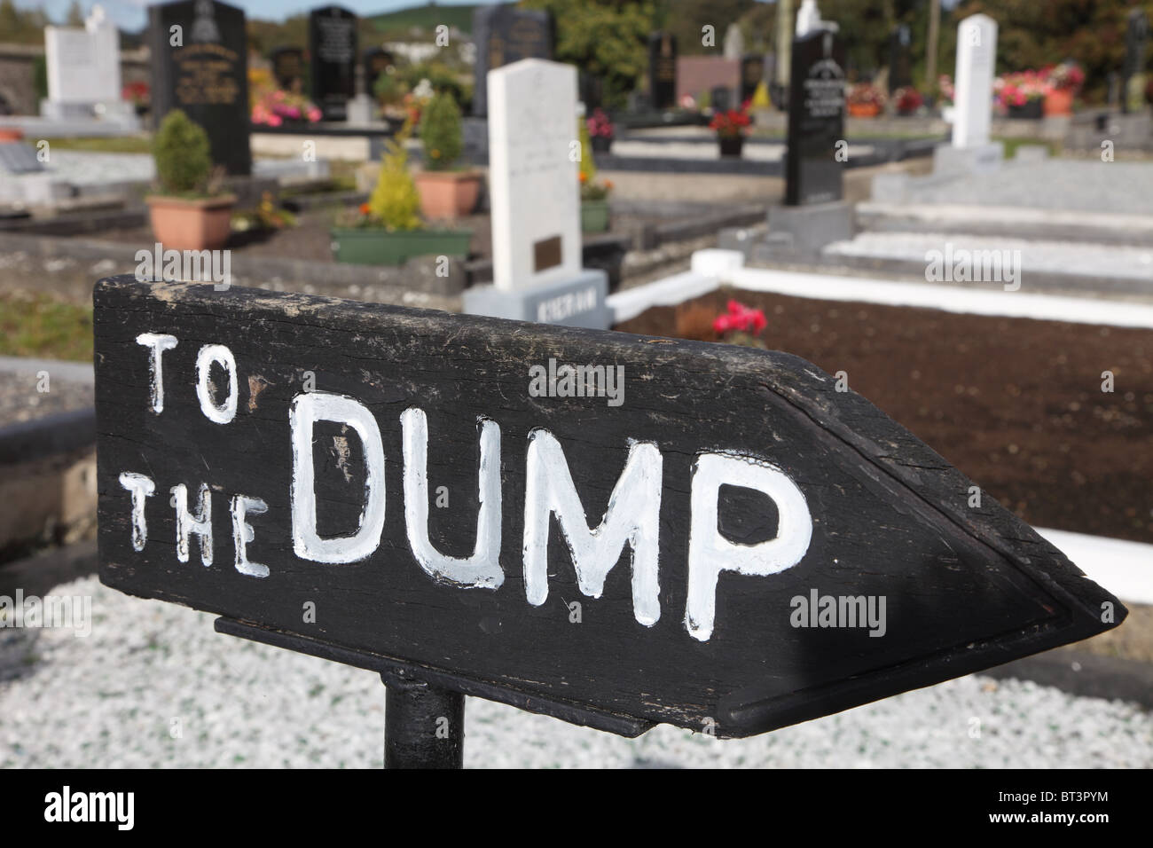 To the dump, sign in Irish graveyard, Inniskeen, Co. Louth, Ireland Stock Photo