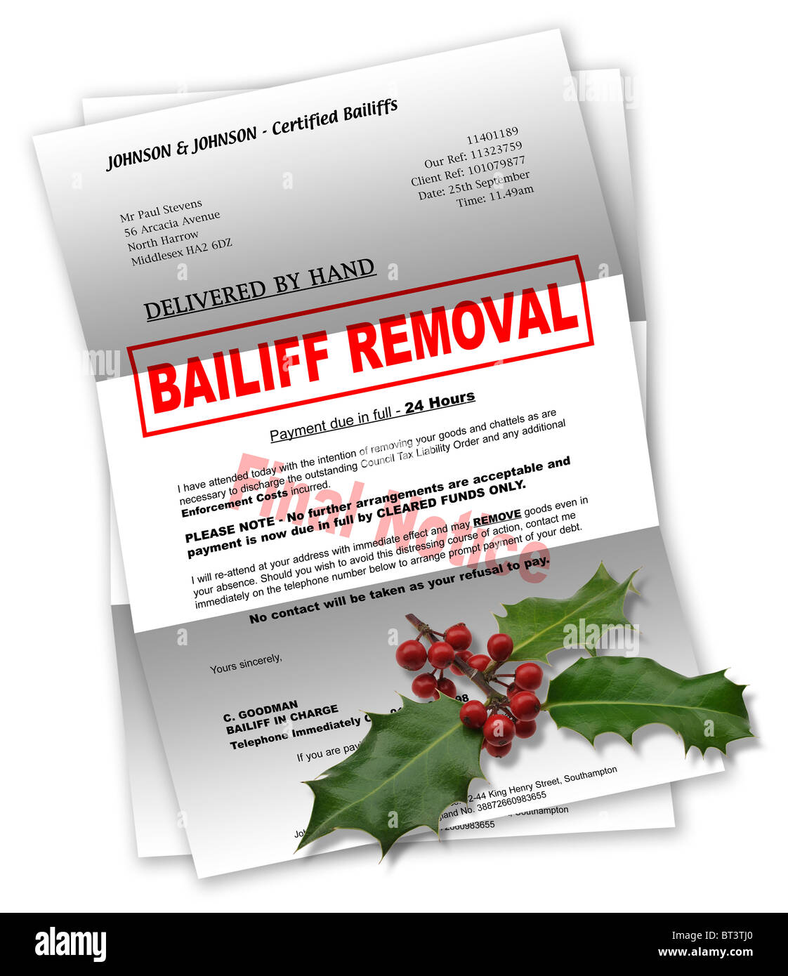 Bailiff letter with Christmas holly on top Stock Photo