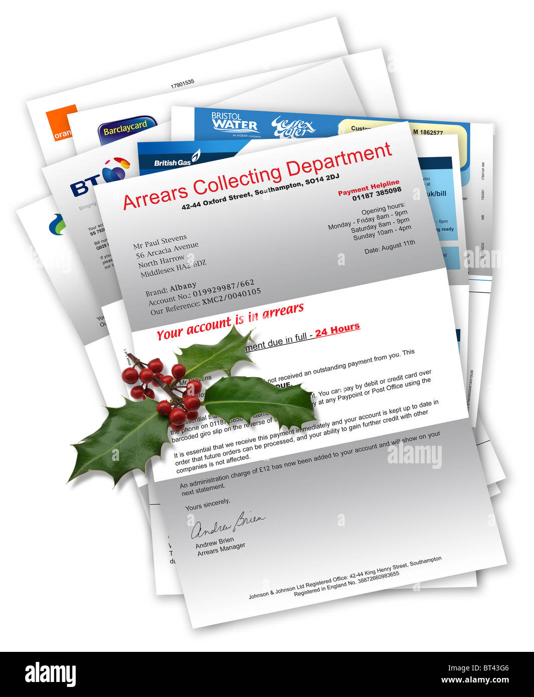 Collection Agency Letter with household bills beneath with Christmas holly on top Stock Photo