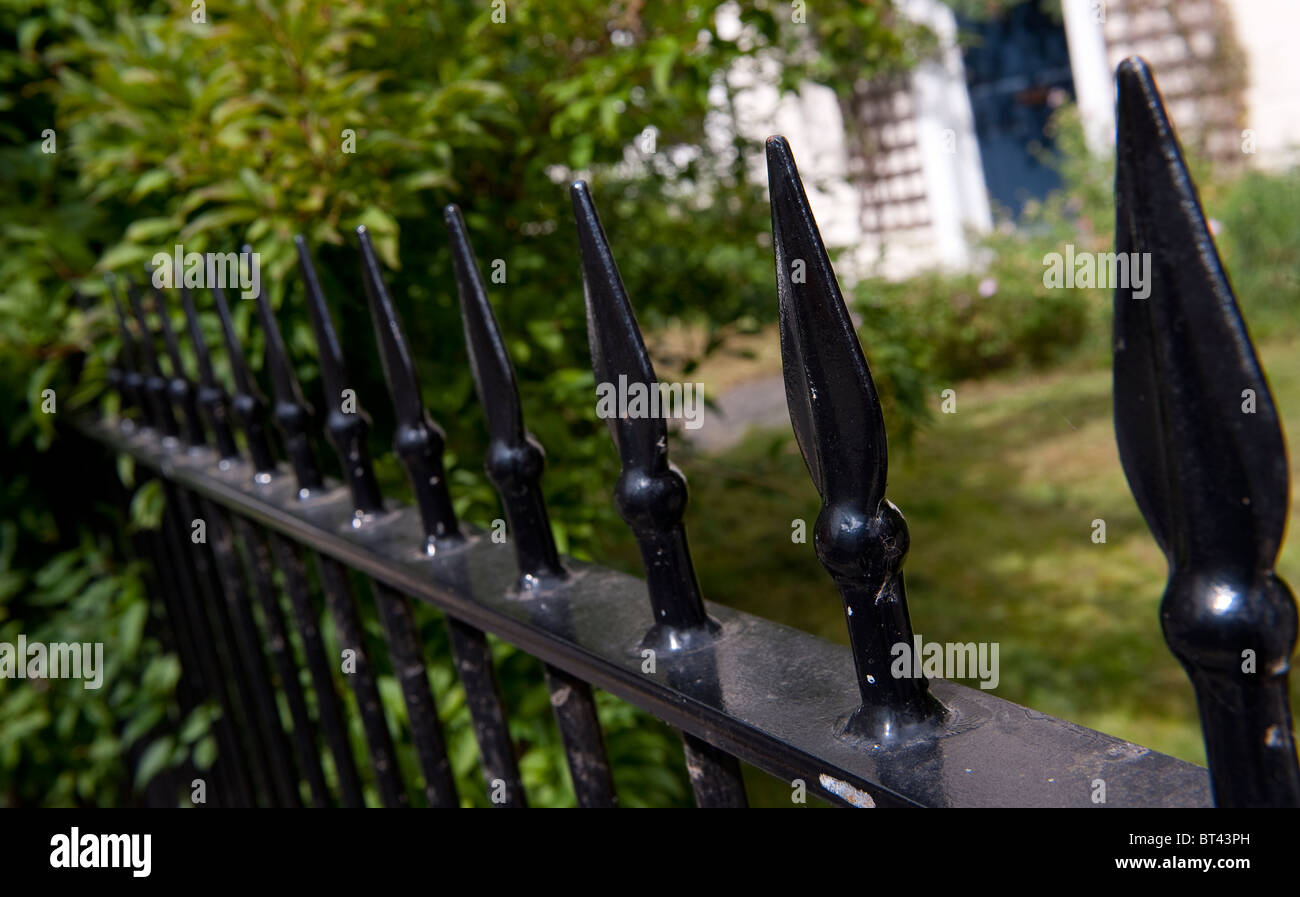 Spikes on top of a metal railing fence in an English town Stock Photo ...