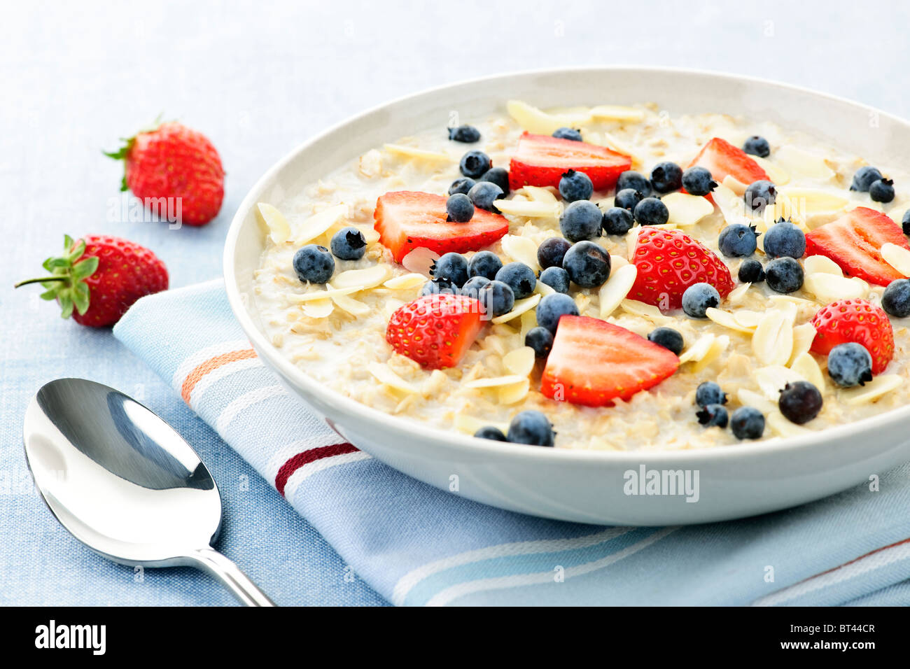 Bowl of hot oatmeal breakfast cereal with fresh berries Stock Photo