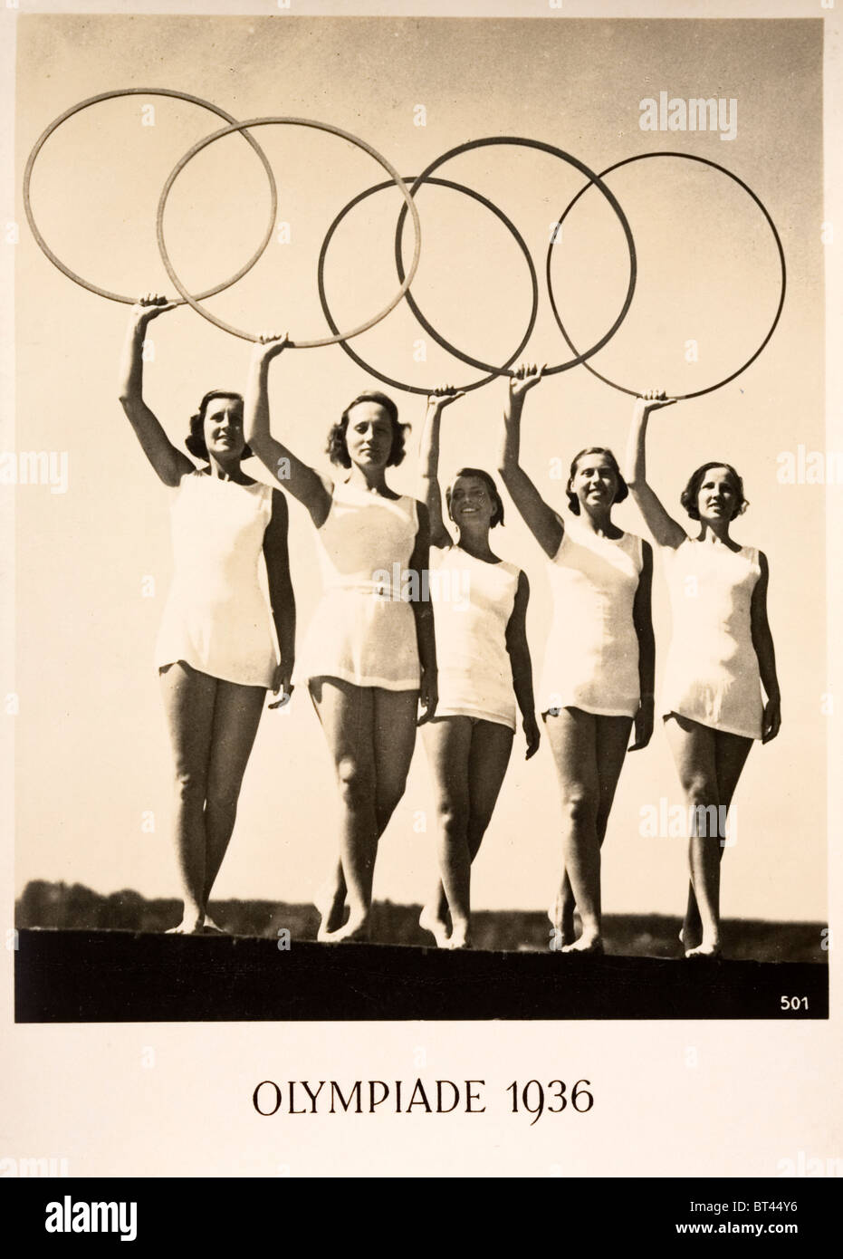 Olympiade 1936. Publicity postcard for the 1936 Berlin Olympic Games. Five women holding up the five hoops Stock Photo