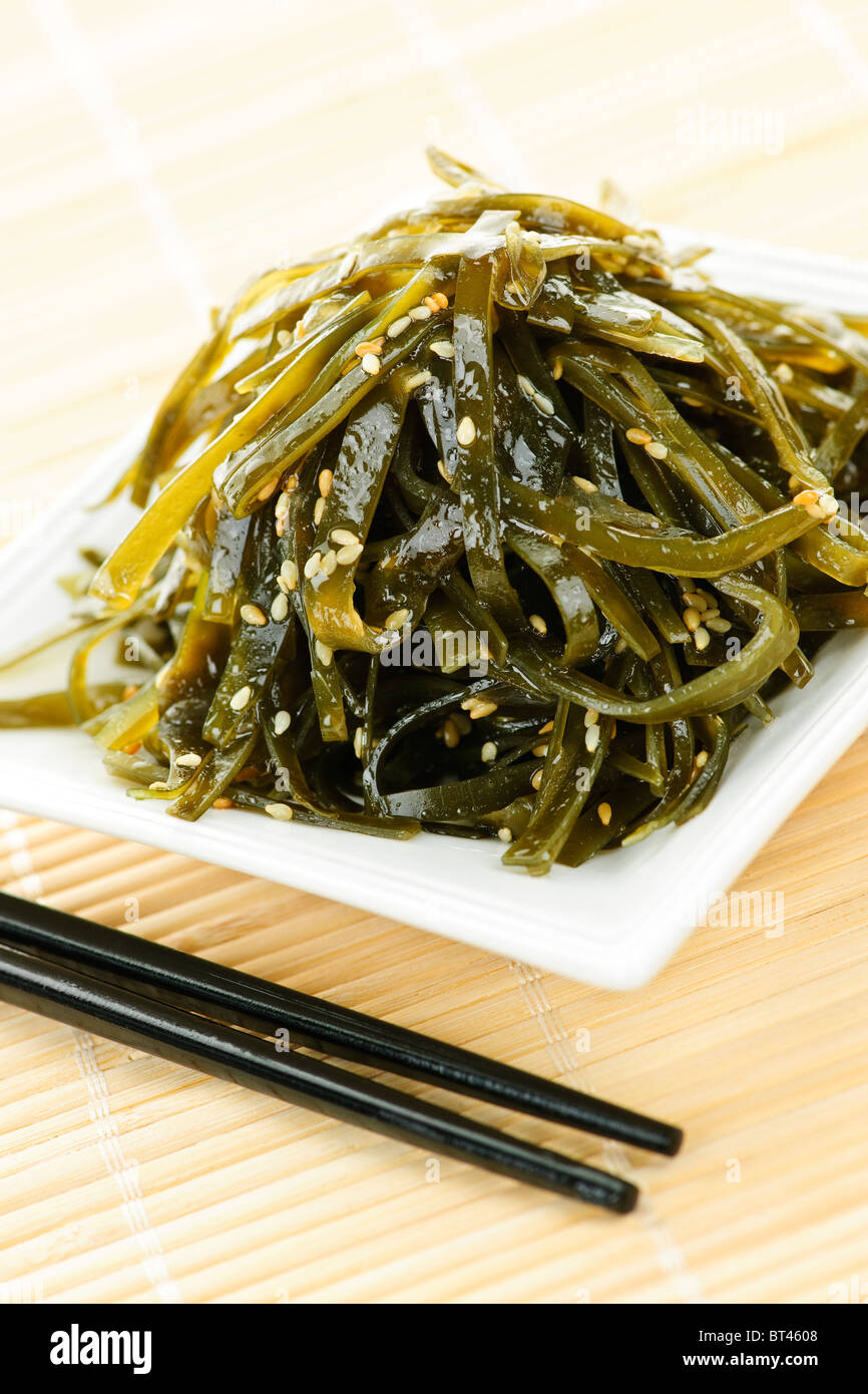 Plate of wakame seaweed salad with chopsticks Stock Photo