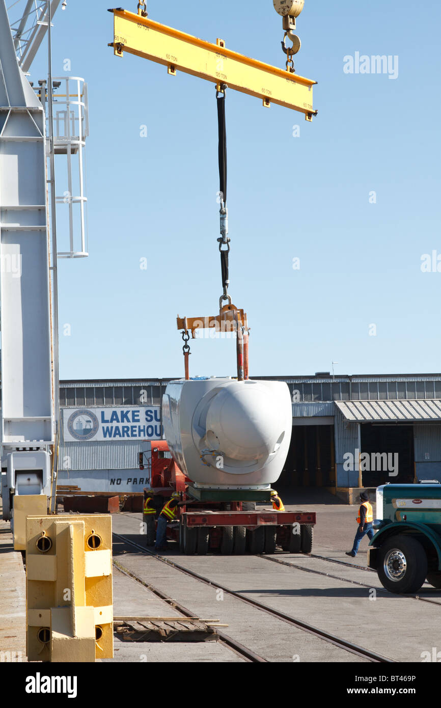 A wind turbine gets loaded onto a semi at a port terminal in Duluth, Minnesota Stock Photo