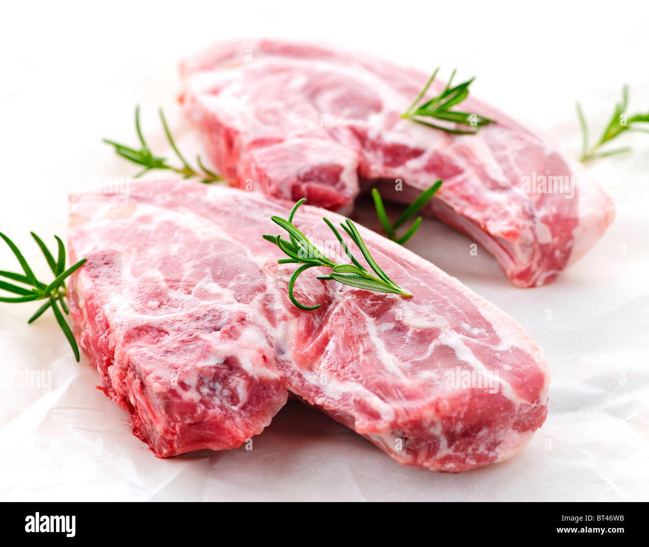 Two raw fresh lamb chops with rosemary herb Stock Photo Alamy