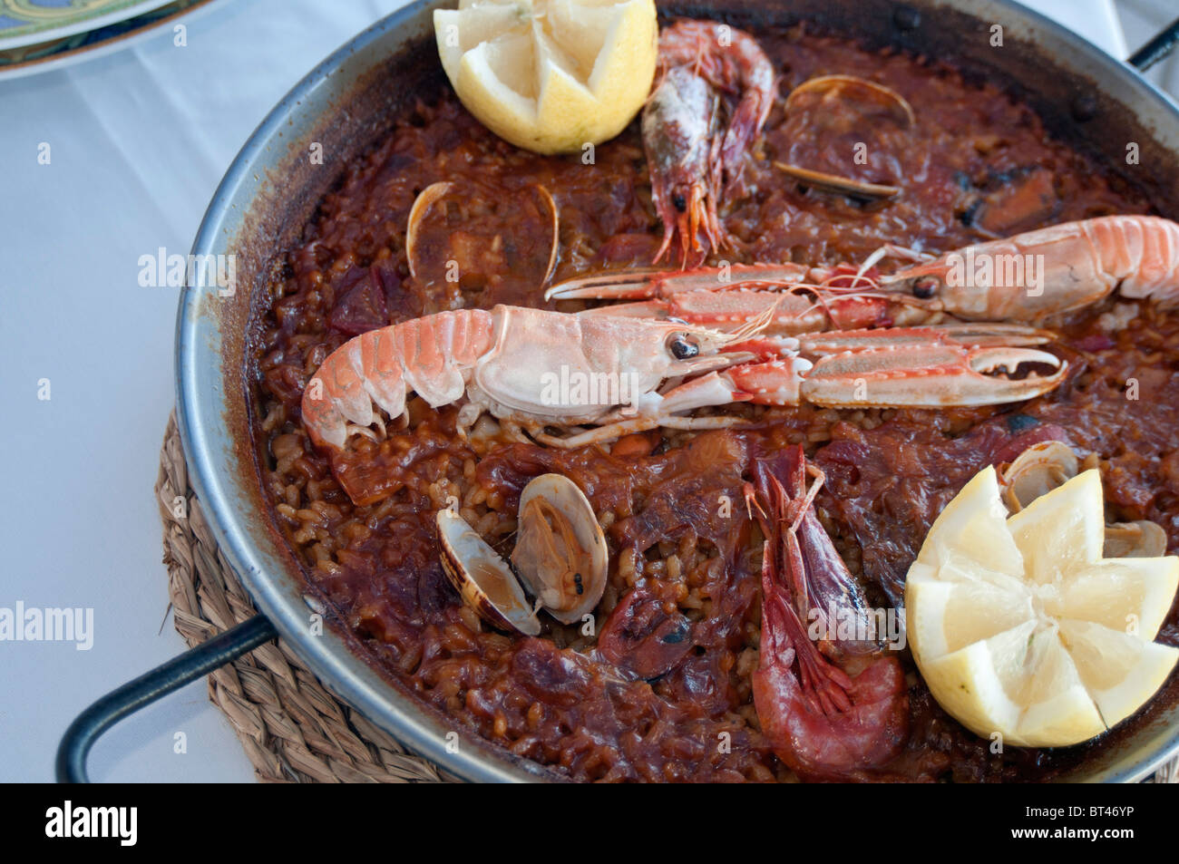 A delicious Seafood Paella in a Paella Pan in a restaurant in Murcia South Eastern Spain Stock Photo
