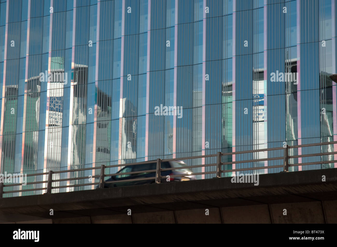 Vehicle on the Mancunian Way against the backdrop of  a Manchester Metropolitan University building. Stock Photo