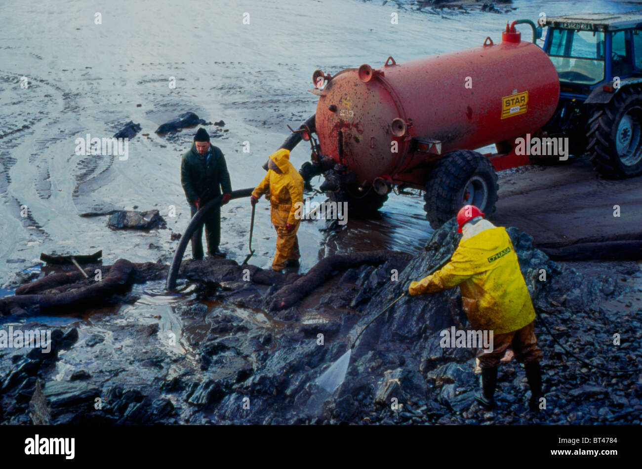 Workers removing oil from beach following the Sea Empress oil tanker