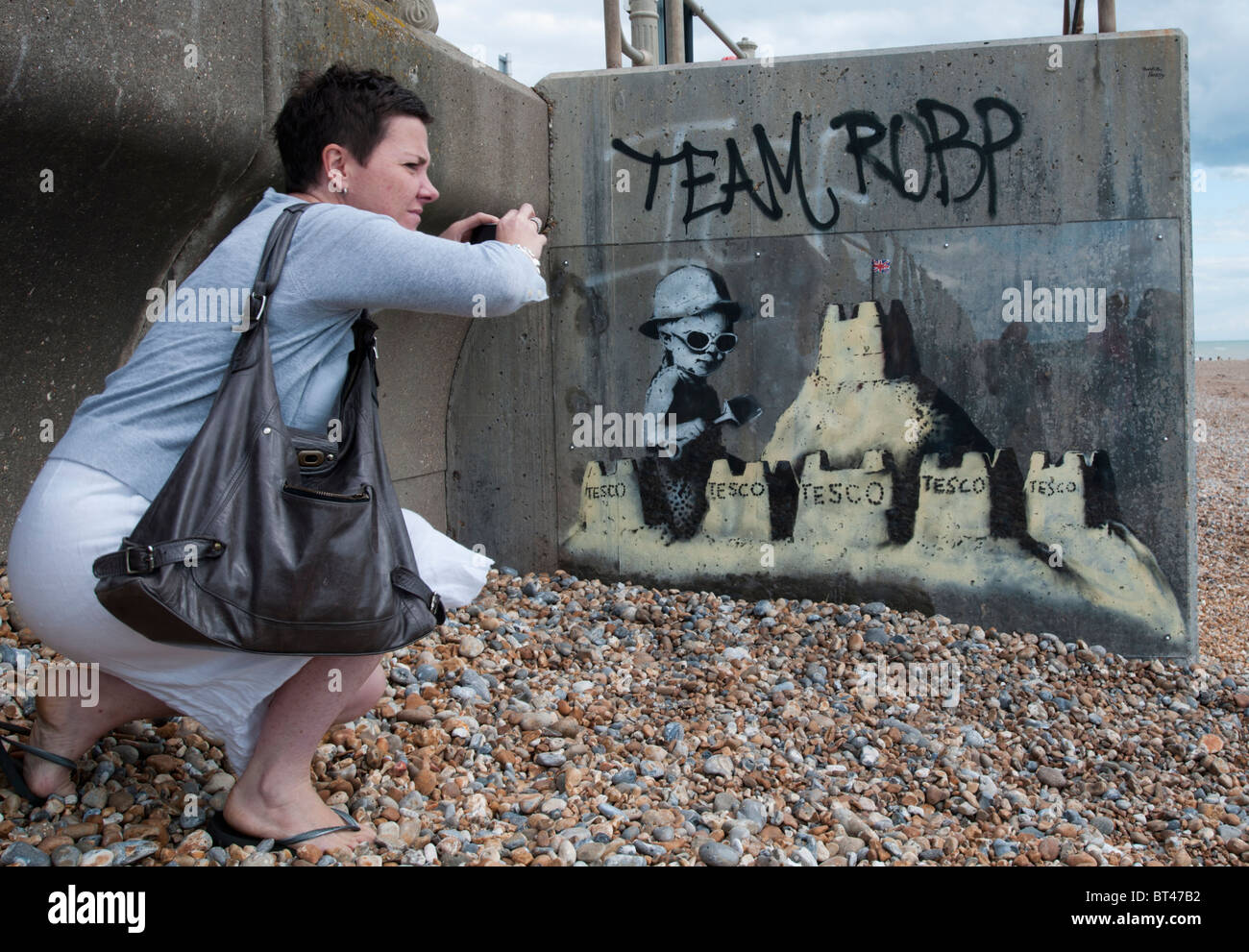 ST. LEONARDS ON SEA, ENGLAND - AUGUST 28: A mural thought to be by Banksy on the seafront attracts attention. Stock Photo