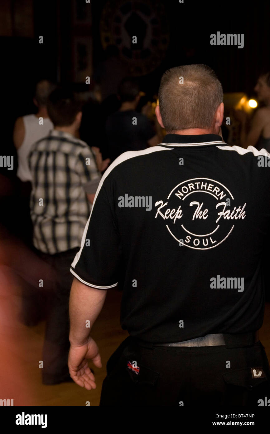 A man dancing to Northern Soul and Motown music with a t-shirt displaying the slogan 'Keep The Faith' UK Stock Photo