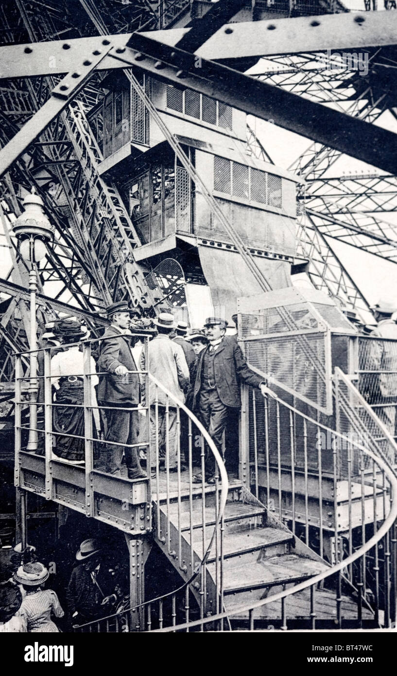 Tourists visiting the Eiffel Tower. About 1910. Shows one of the two storey lifts. Stock Photo