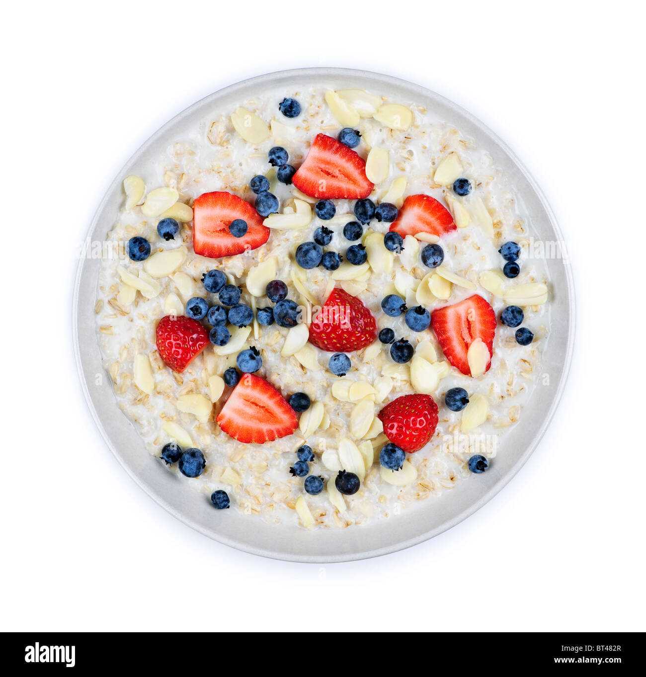 Bowl of hot oatmeal breakfast cereal with fresh berries from above