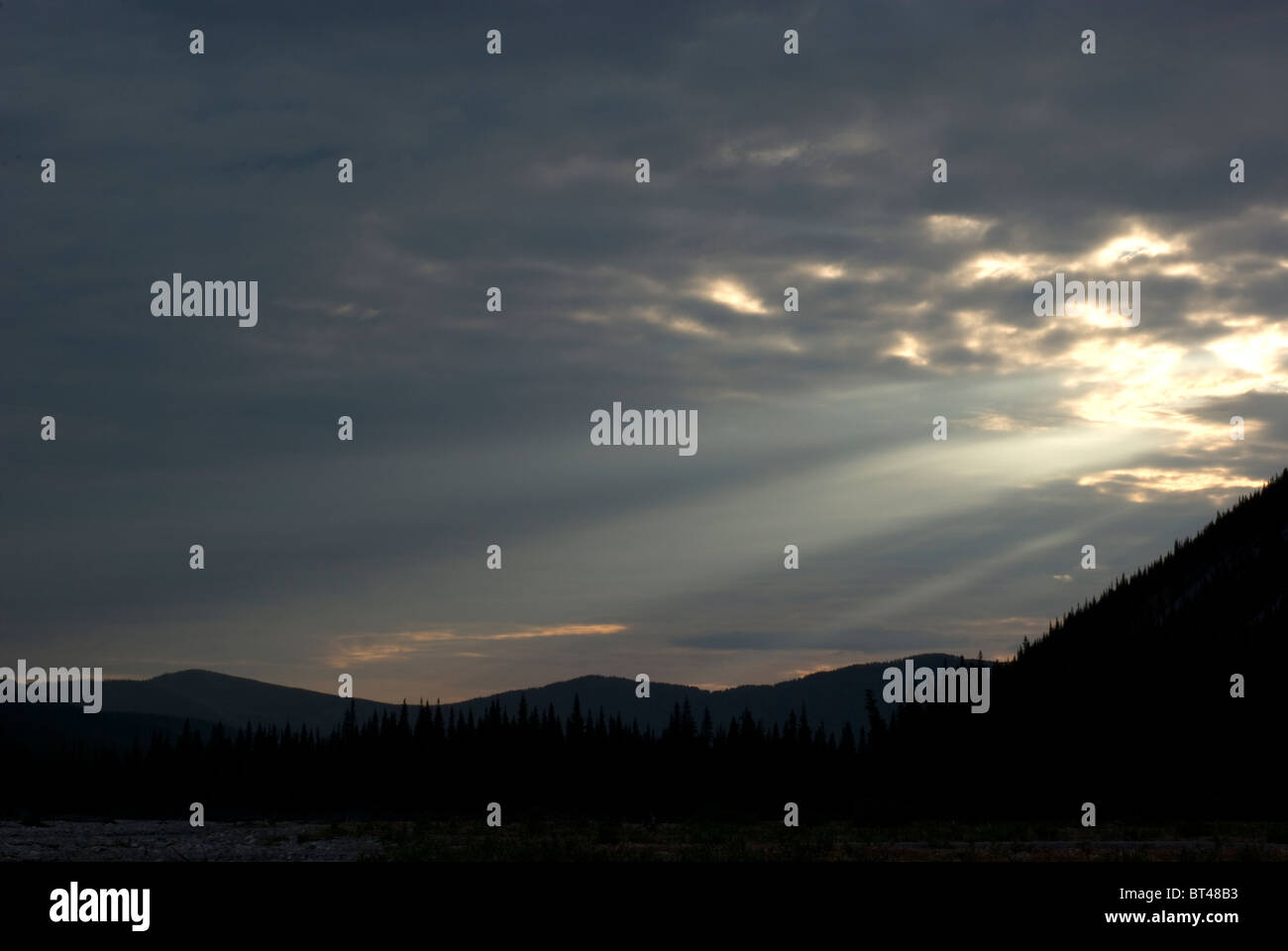 Sunlight through clouds in mountains Stock Photo