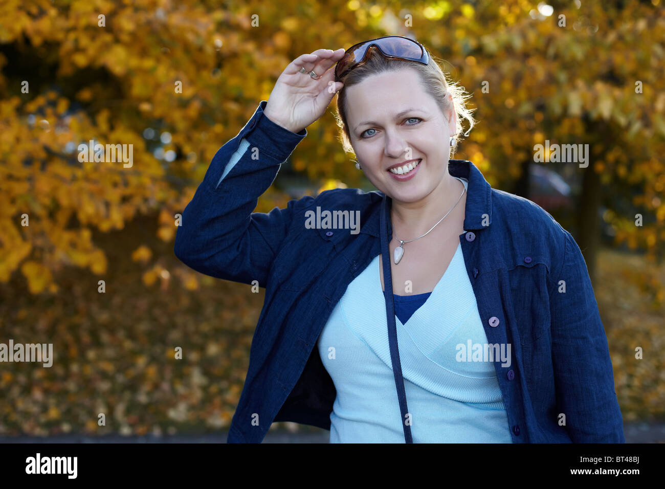 Smiling woman in a park Stock Photo - Alamy