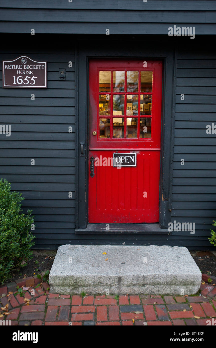 Red door entrance to the Retire Beckett House, circa 1655, home of the museum shop for the House of Seven Gables Stock Photo