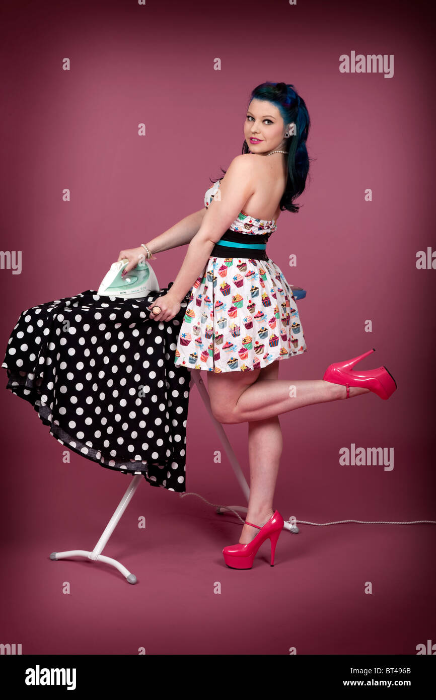 Pin-Up style photo of a young woman ironing Stock Photo - Alamy