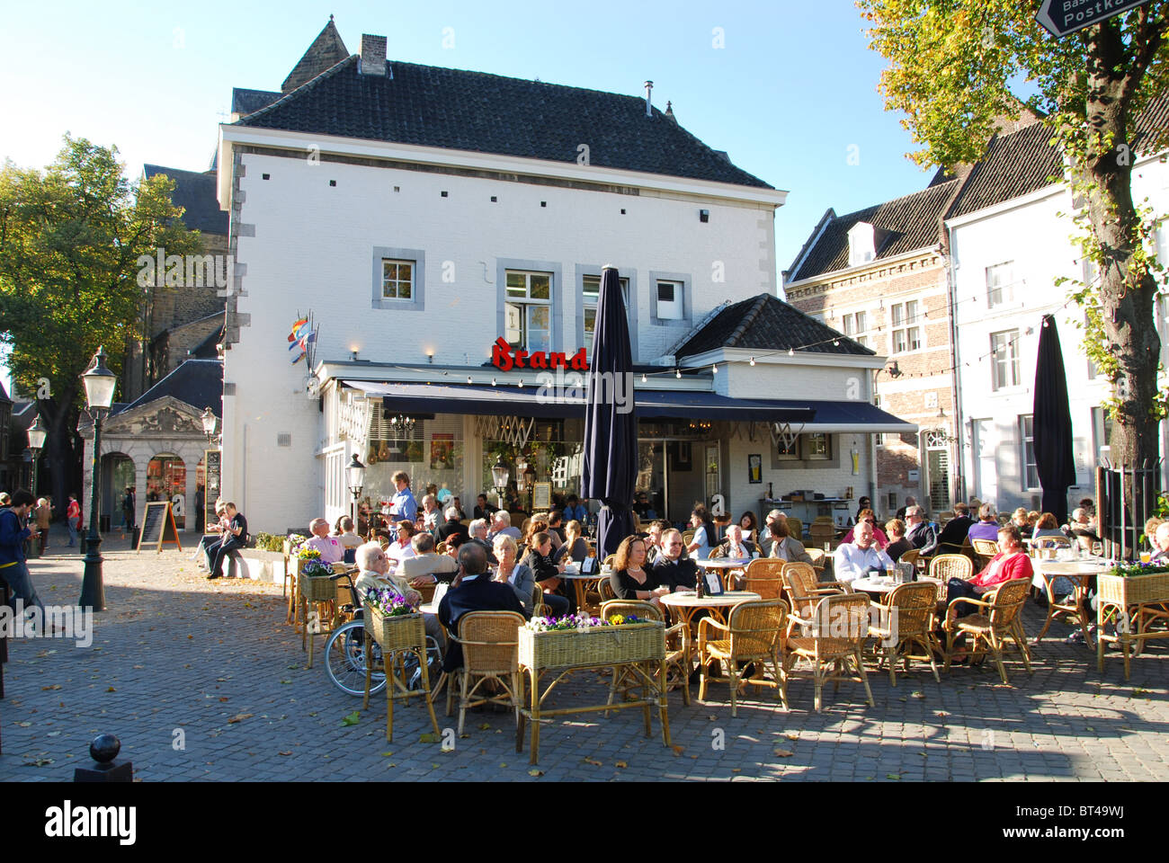 terraces with people enjoying summer sunshine at cafe La Bonne Femme Maastricht Netherlands Stock Photo