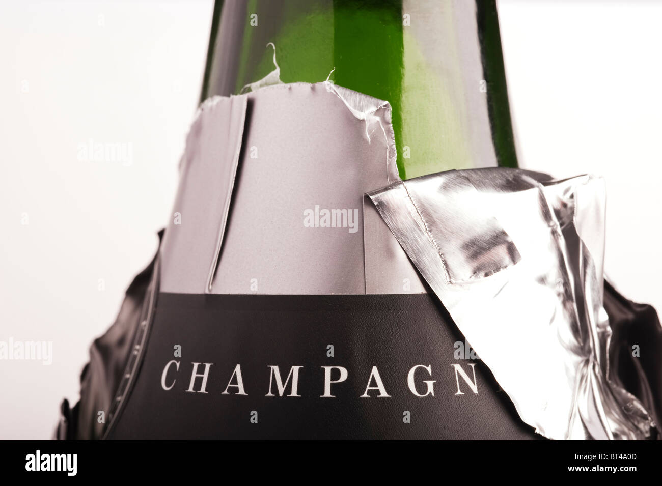 An opened champagne bottle foil neck label in closeup Stock Photo