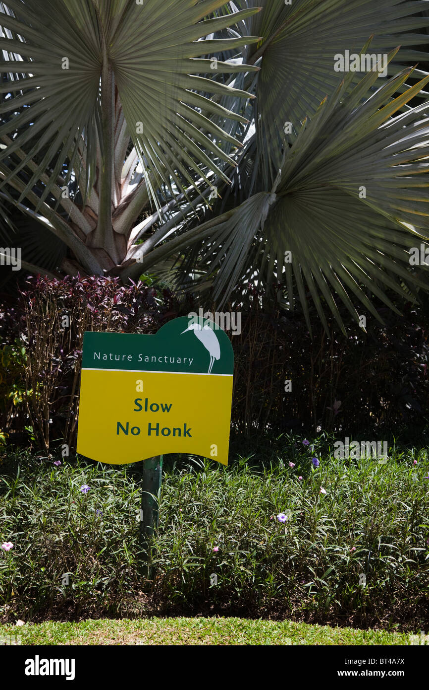 Humorous road sign with a sign of a heron,  Barbados outside a nature reserve so that visitors don't frighten the bird life. Stock Photo