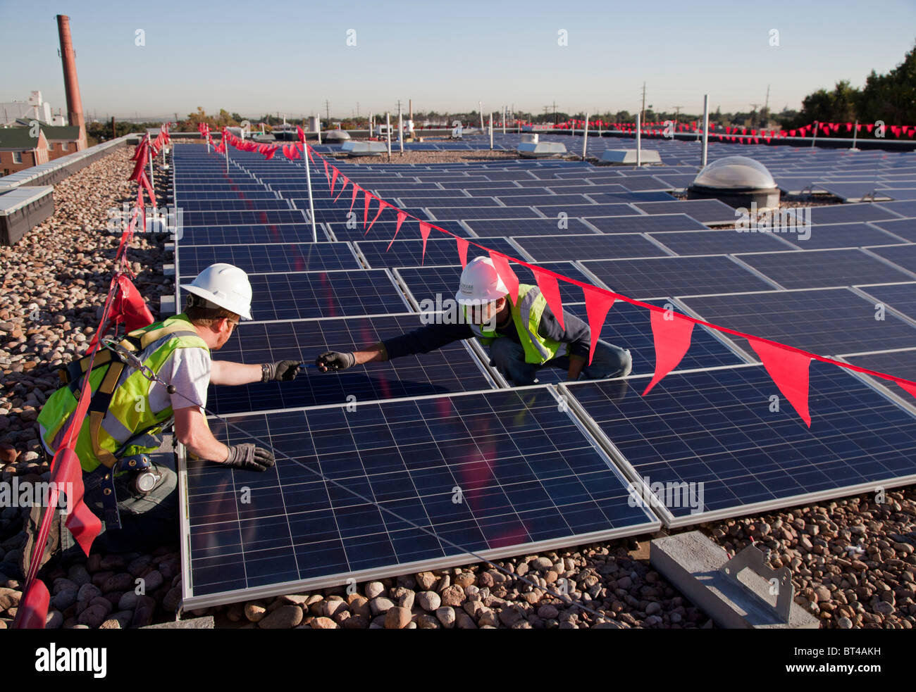 Workers Install Solar Panels on Roof of an Elementary School Stock Photo Alamy