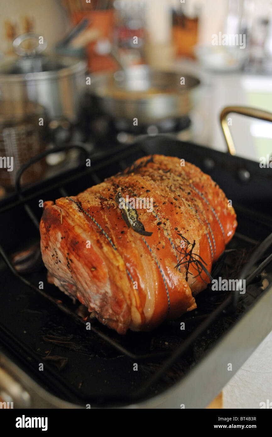 Joint of pork roasted with sage and rosemary for Sunday lunch UK Stock Photo