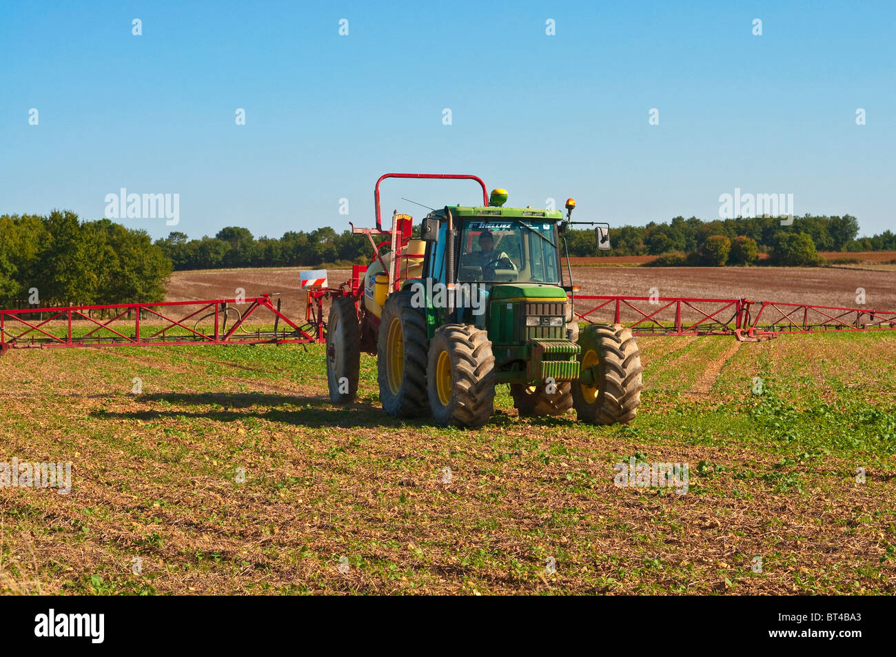 Hardi Commander crop sprayer behind John Deere 6400 tractor - France.