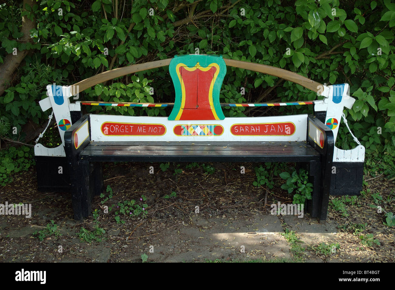 wooden memorial bench in memory of Sarah Jane, Whilton Locks on the Grand Union Canal, Northamptonshire, England, UK Stock Photo