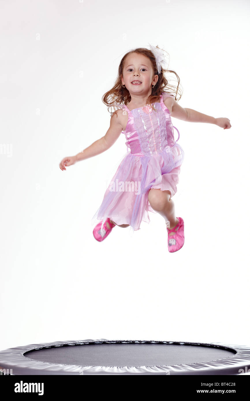Young girl jumping on a trampoline Stock Photo - Alamy