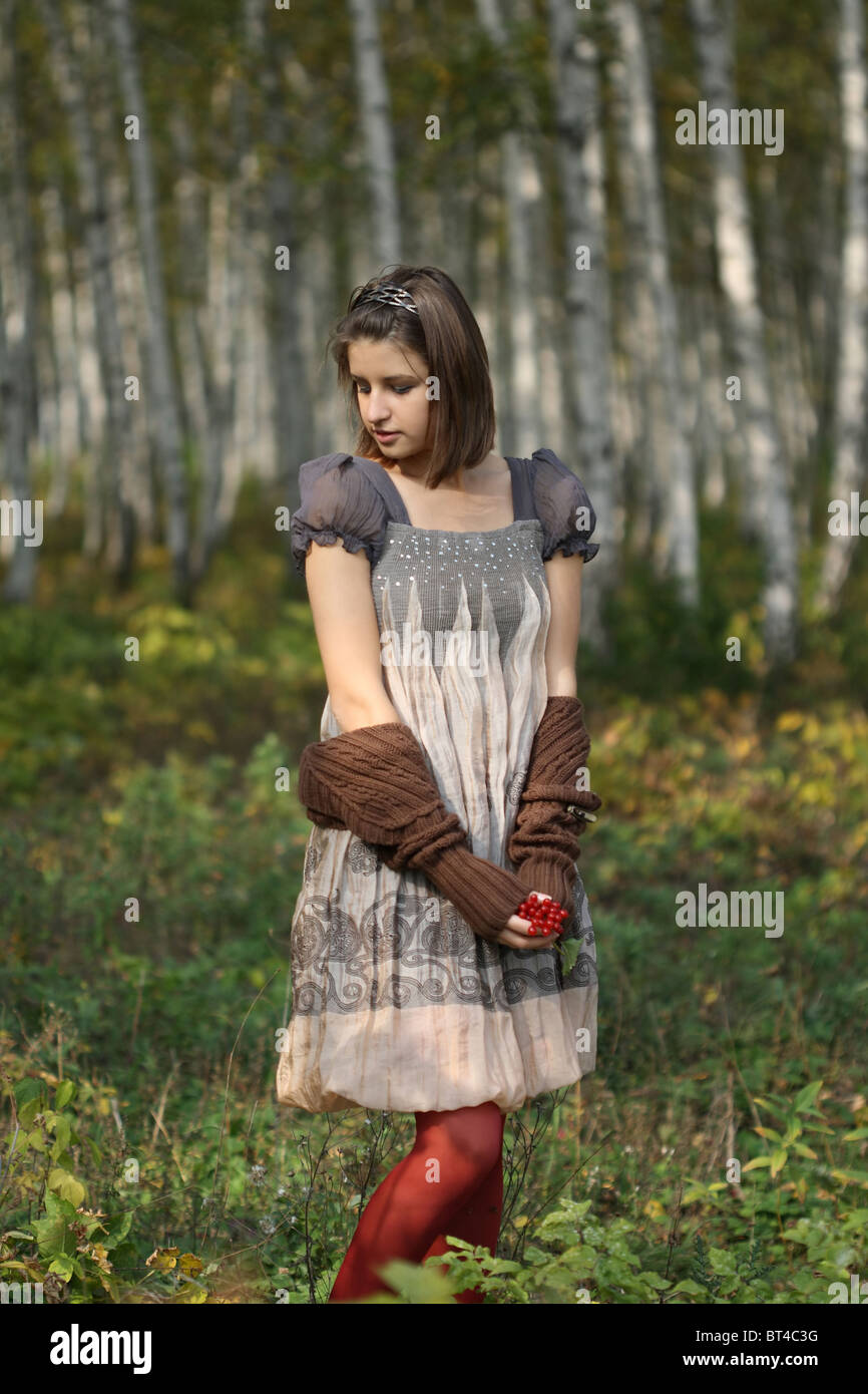Portrait of pretty young girl in autumn forest Stock Photo - Alamy