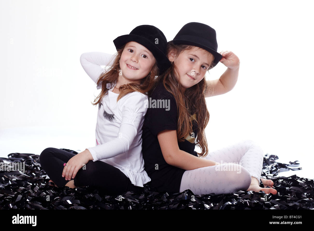 Two young girls in black hats Stock Photo - Alamy