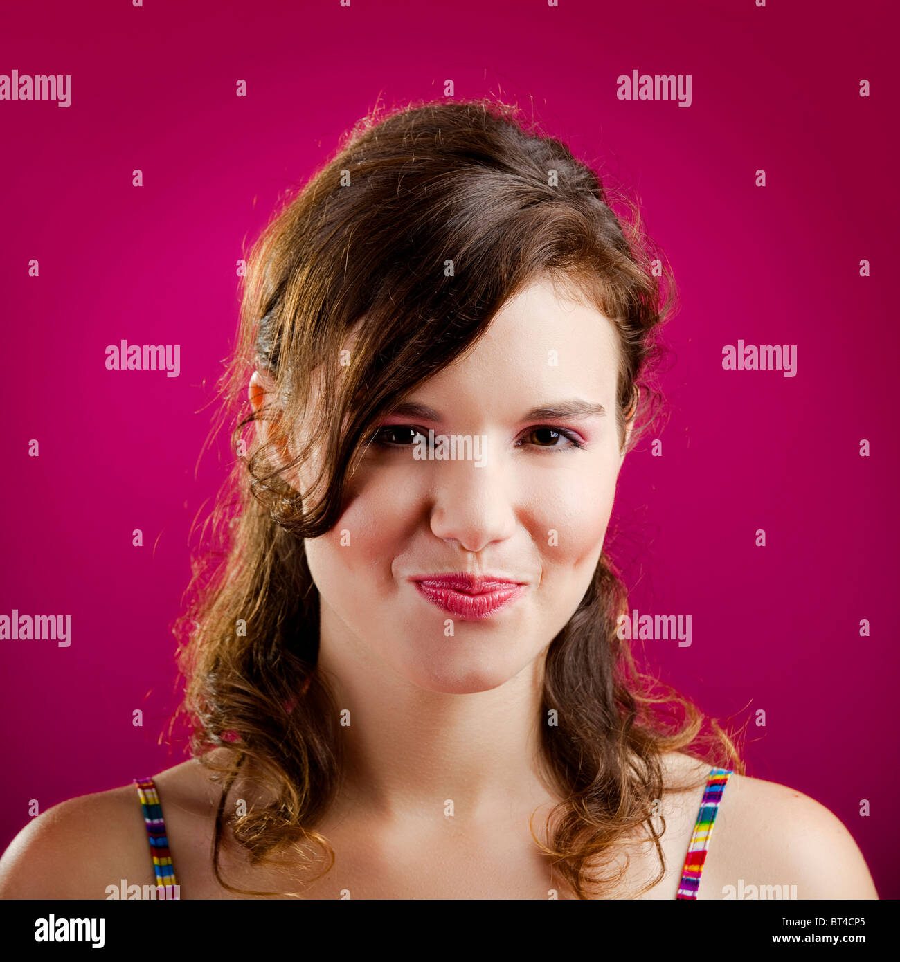 Portrait of a beautiful young woman over a pink background Stock Photo ...