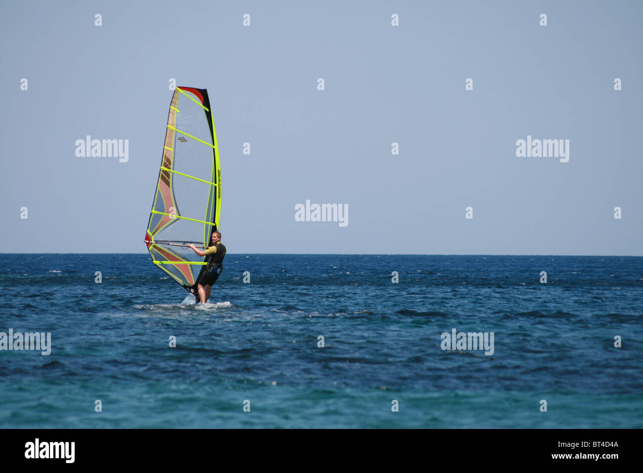A man windsurfing windsurfer, windsurf sea sport vacation blue sky