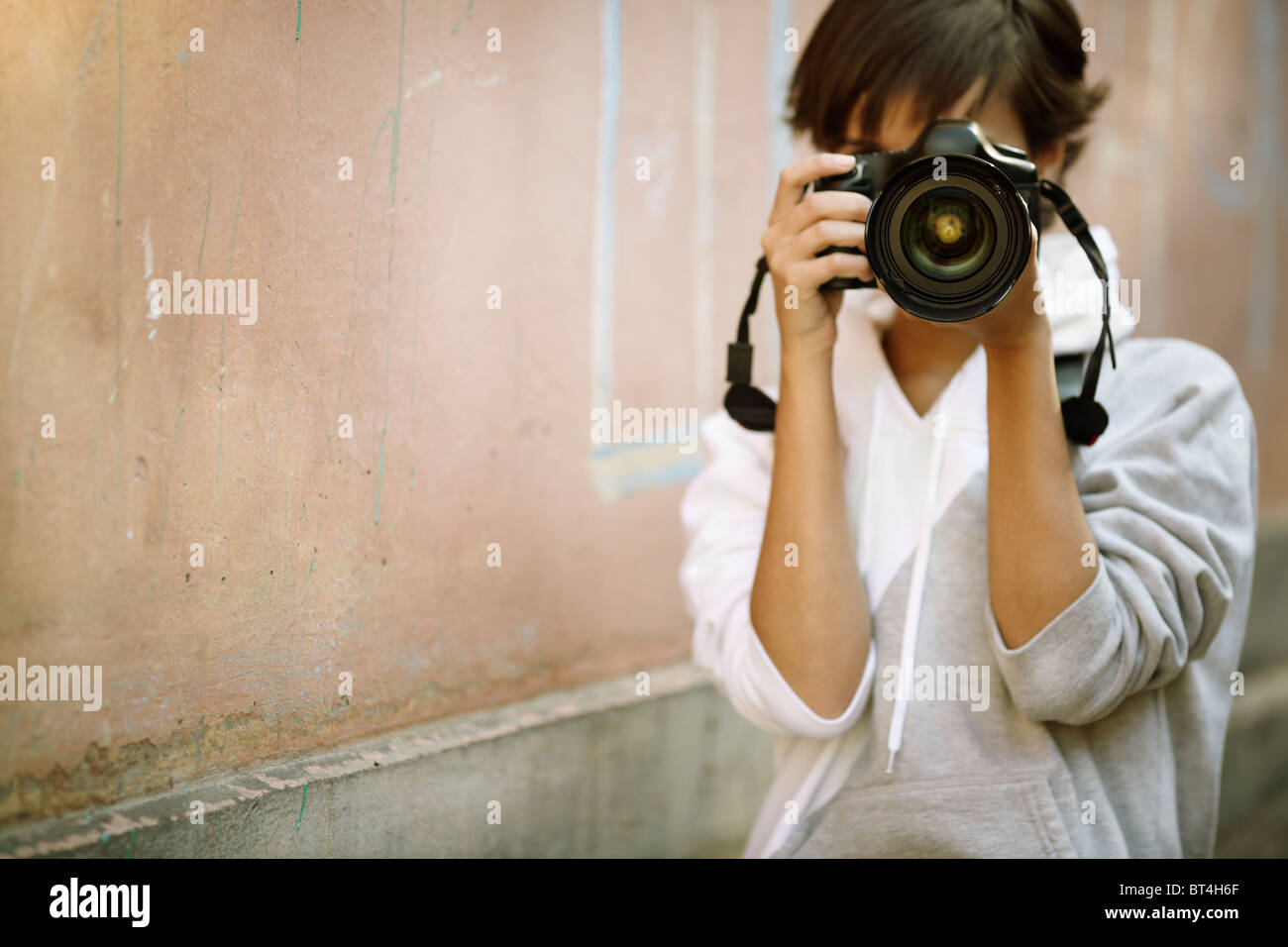 female photographer with professional SLR camera, natural light