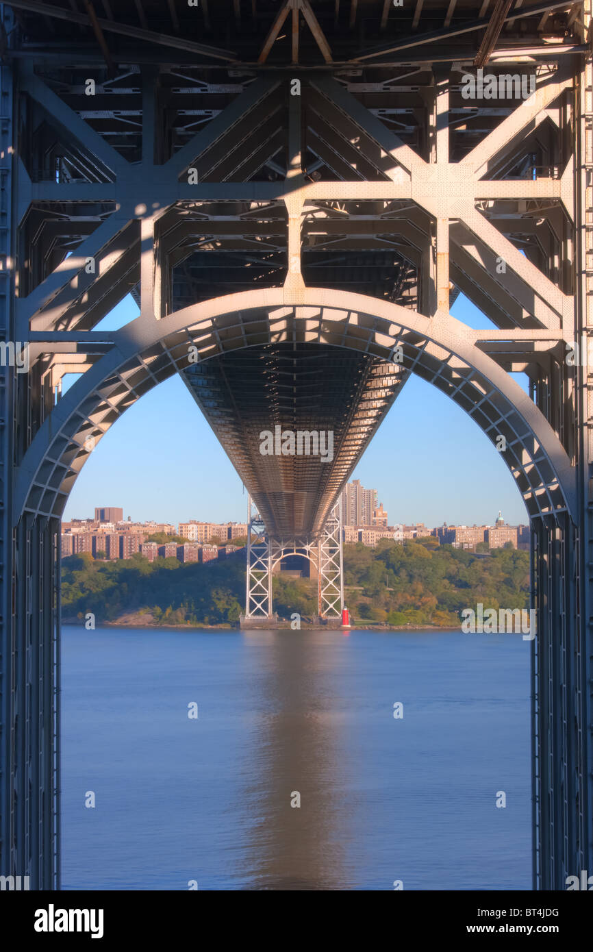 A view underneath the George Washington Bridge with Jeffrey's Hook Lighthouse across the Hudson River in New York City. Stock Photo
