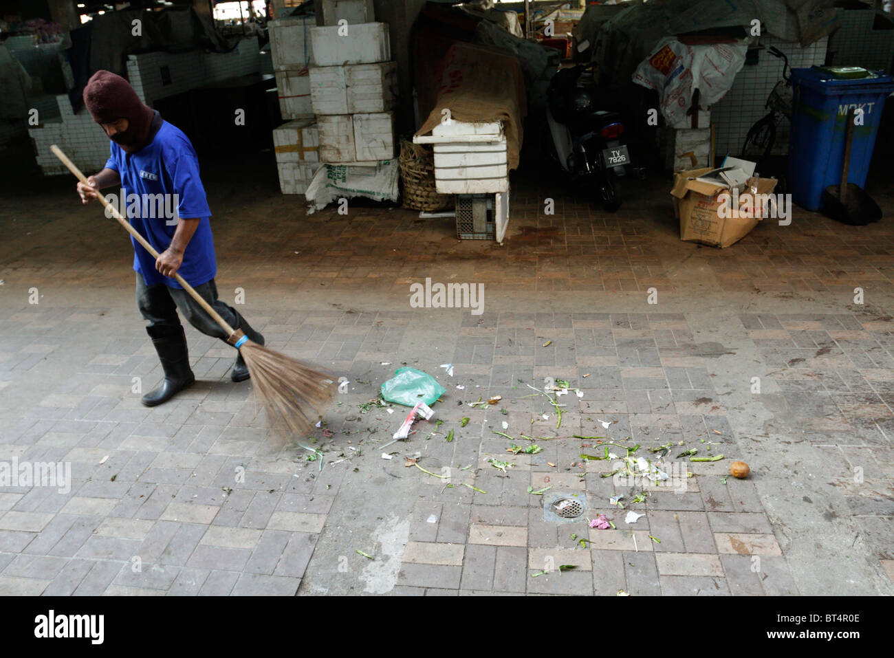 Sweeping the floor at Payang Market in Kuala Terengganu, Malaysia. Stock Photo