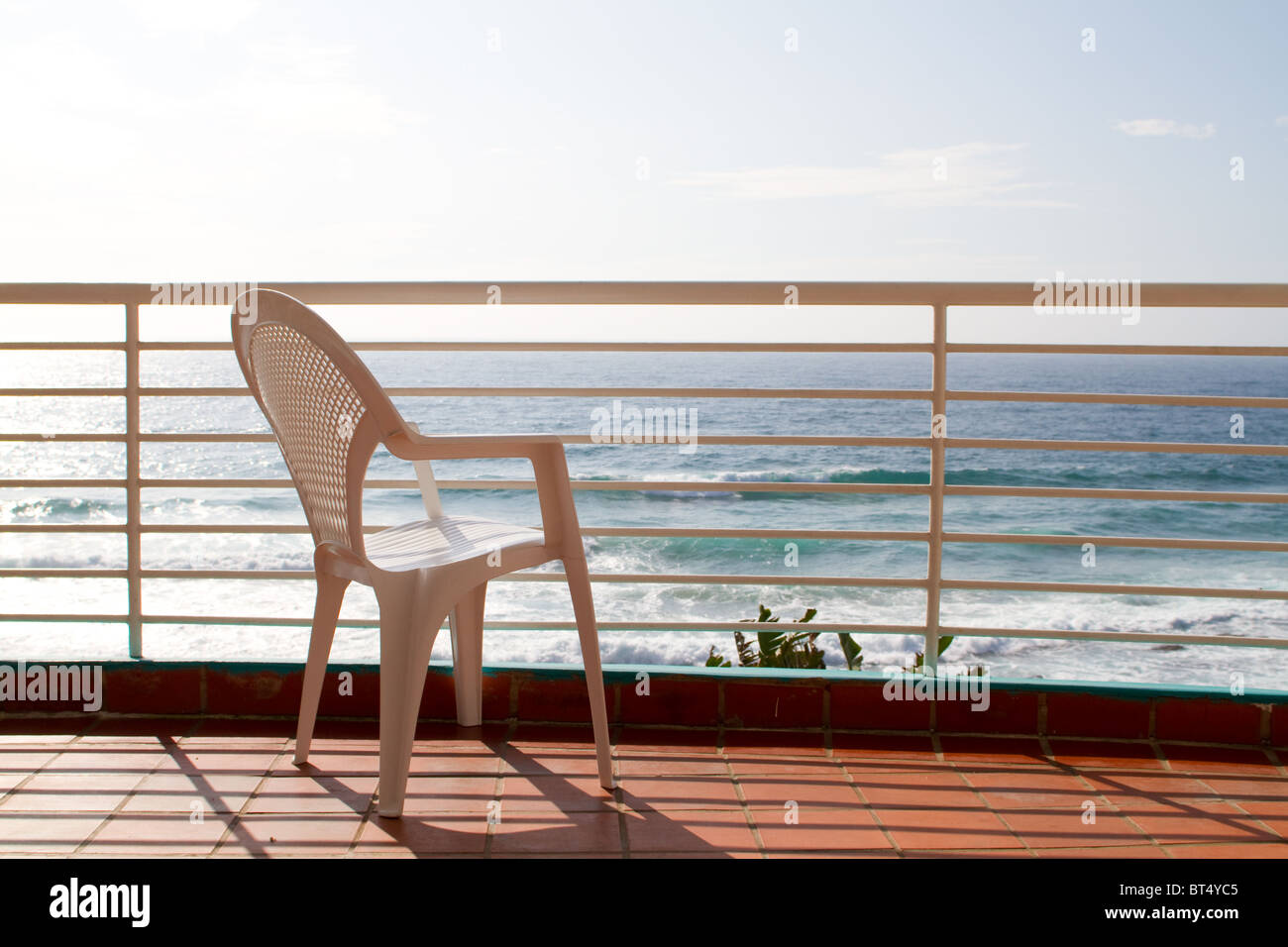 sea view balcony with empty chair Stock Photo