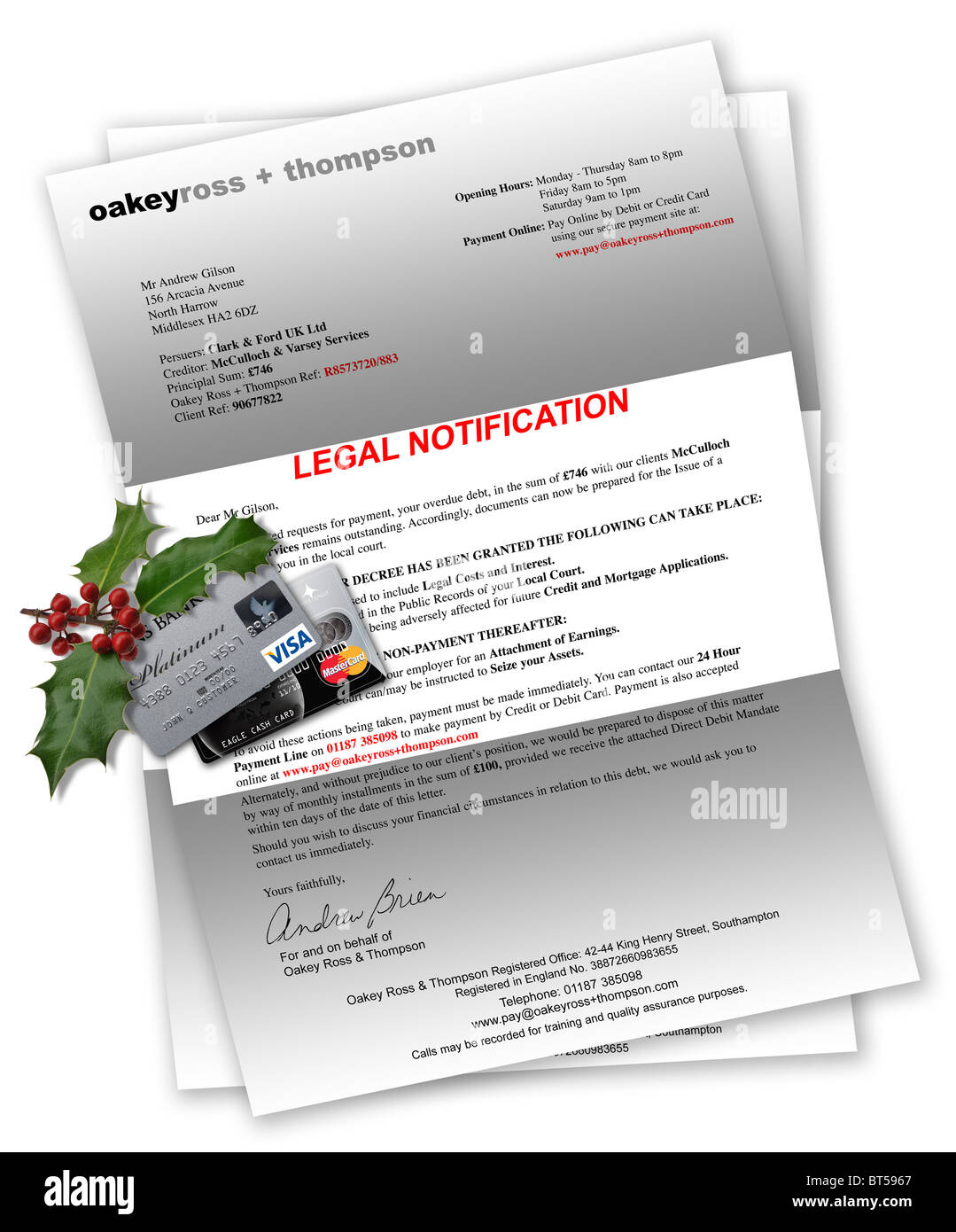 Legal Notification letter with credit cards and Christmas holly on top Stock Photo