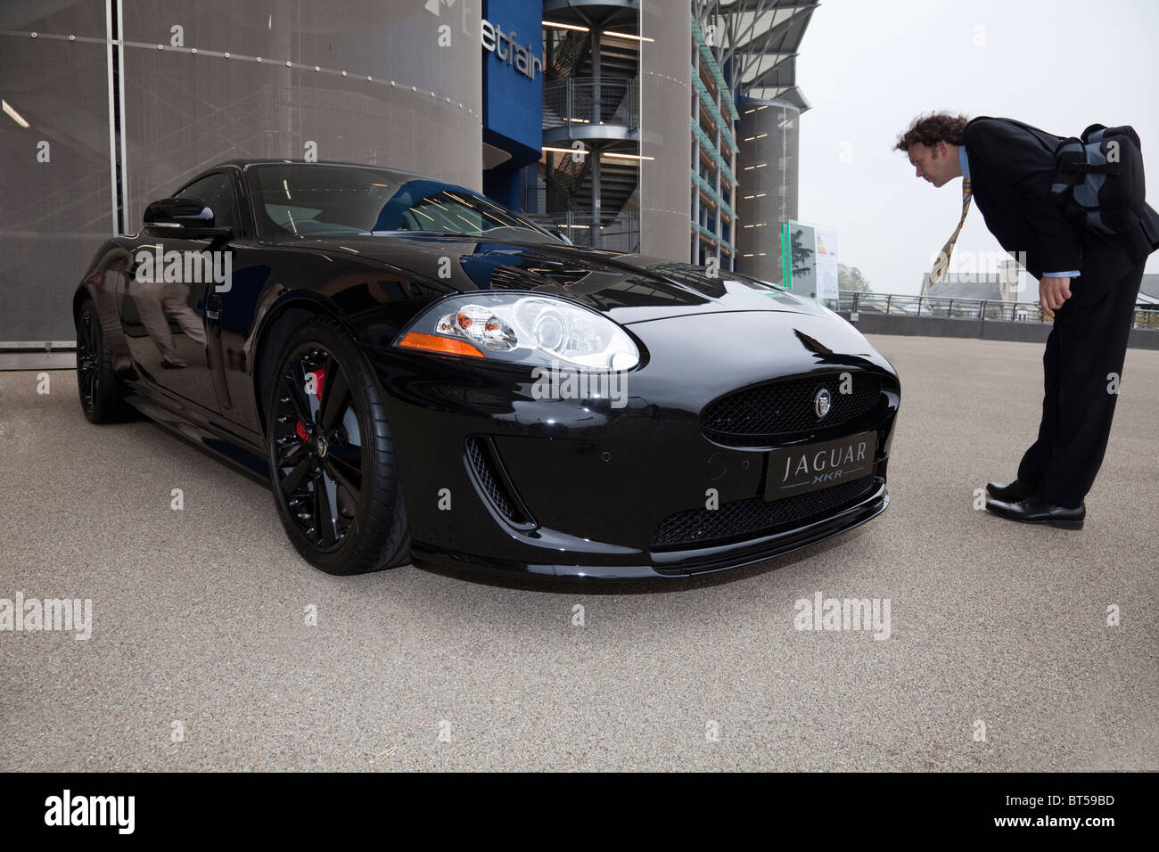 Jaguar XKR car being examined by man Stock Photo