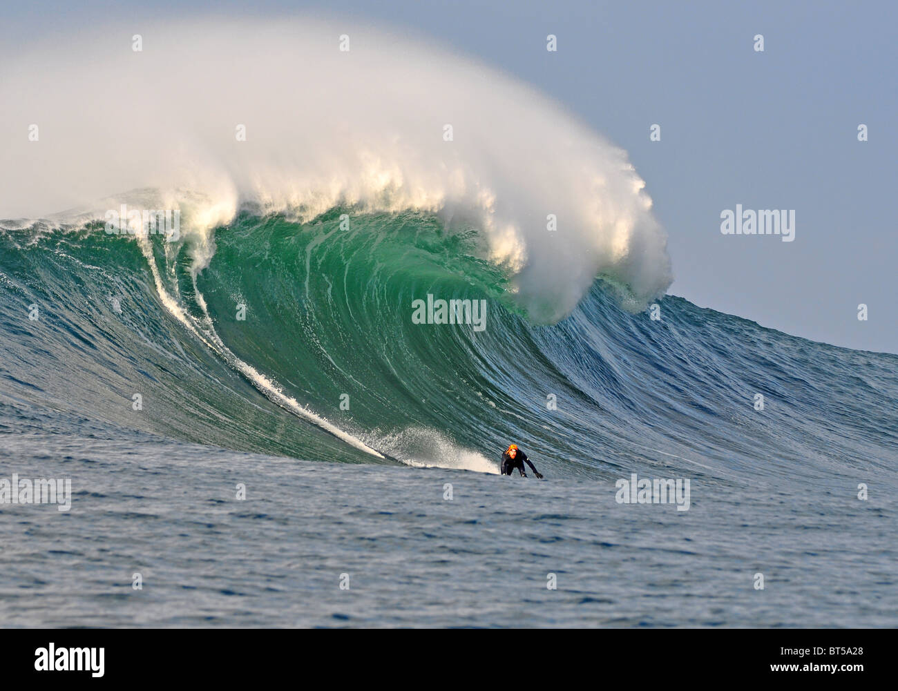 Alistair Mennie surfs a 25 foot wave at the Cliffs of Moher , Co Clare, Ireland Stock Photo