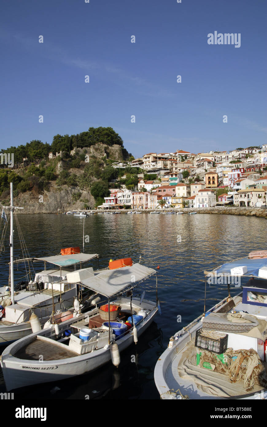 The harbour at Parga, Epirus, Greece, with fishing boats and the Venetian castle and old town in the background. Stock Photo