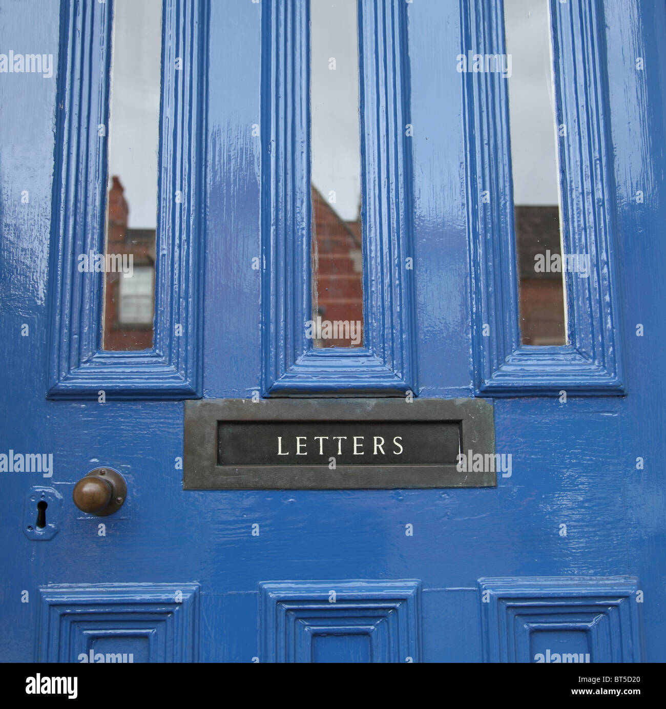 A blue painted door with letterbox. Stock Photo
