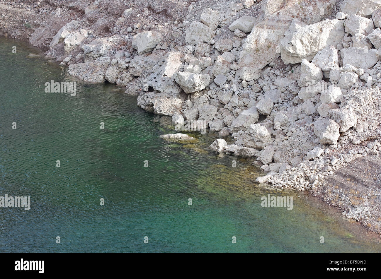 Rocks around Lake Mead, near the Hoover Dam, whitened due to calcium deposits where the water level has recently gone down Stock Photo