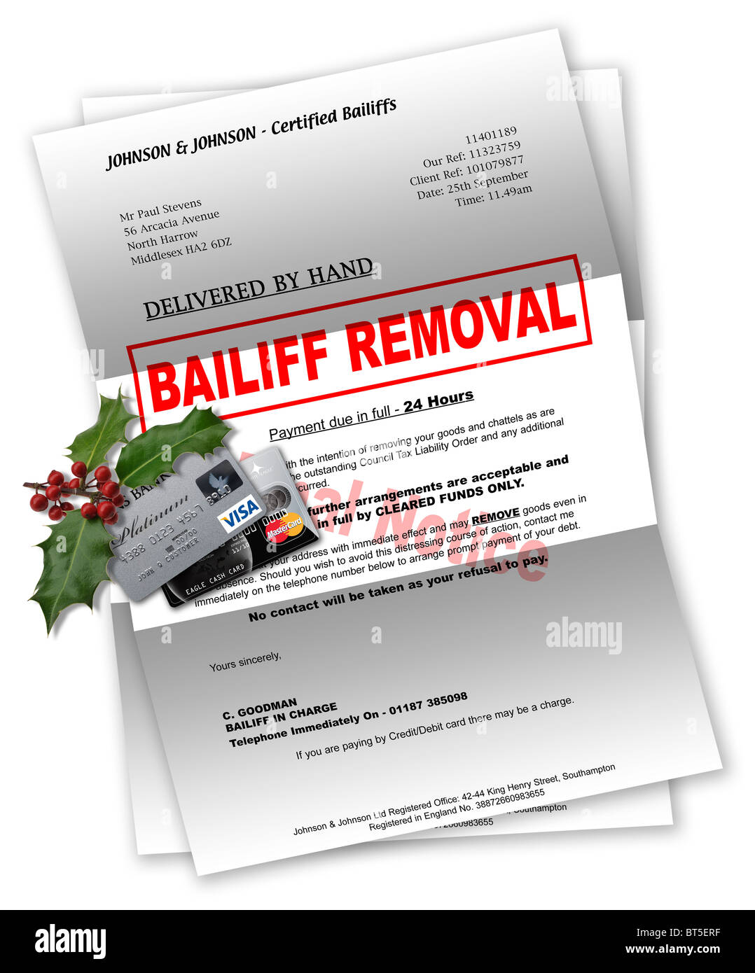 Bailiff letter with credit cards and Christmas holly on top Stock Photo