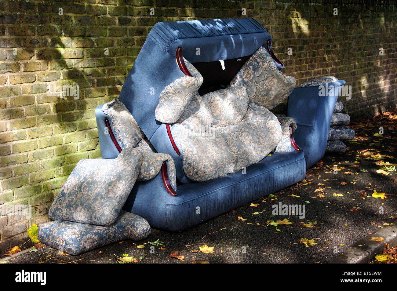 Discarded couch left on street, Stanwell Moor, Surrey, England, United Kingdom Stock Photo