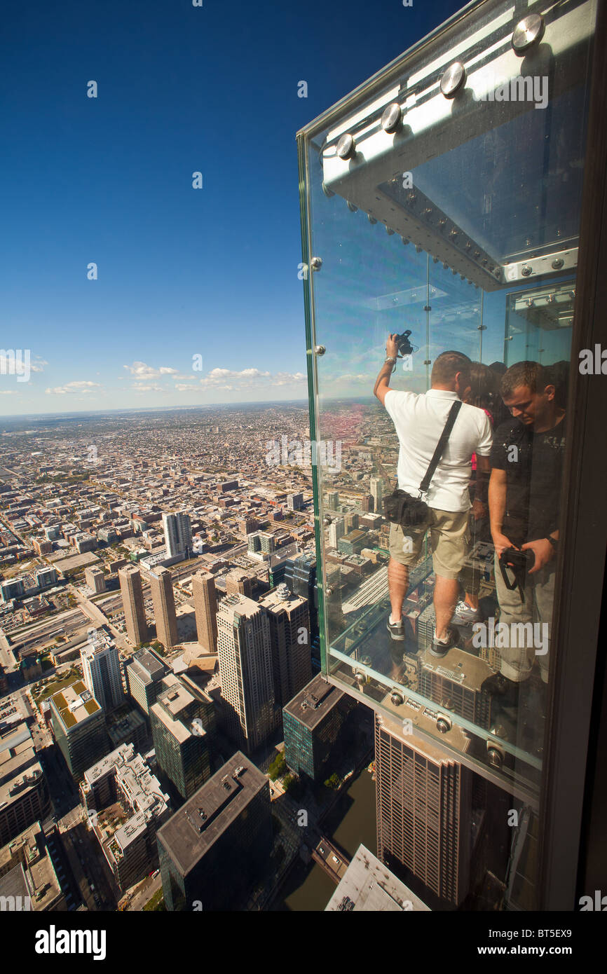 Tourists in the all glass balcony Skydeck observation deck view the Chicago skyline103rd floor of the Willis Sears Tower Stock Photo