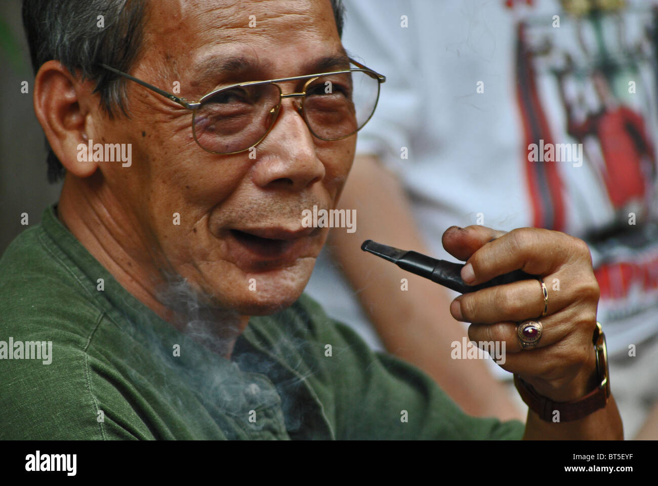 Man smoking pipe in Hanoi, Vietnam Stock Photo