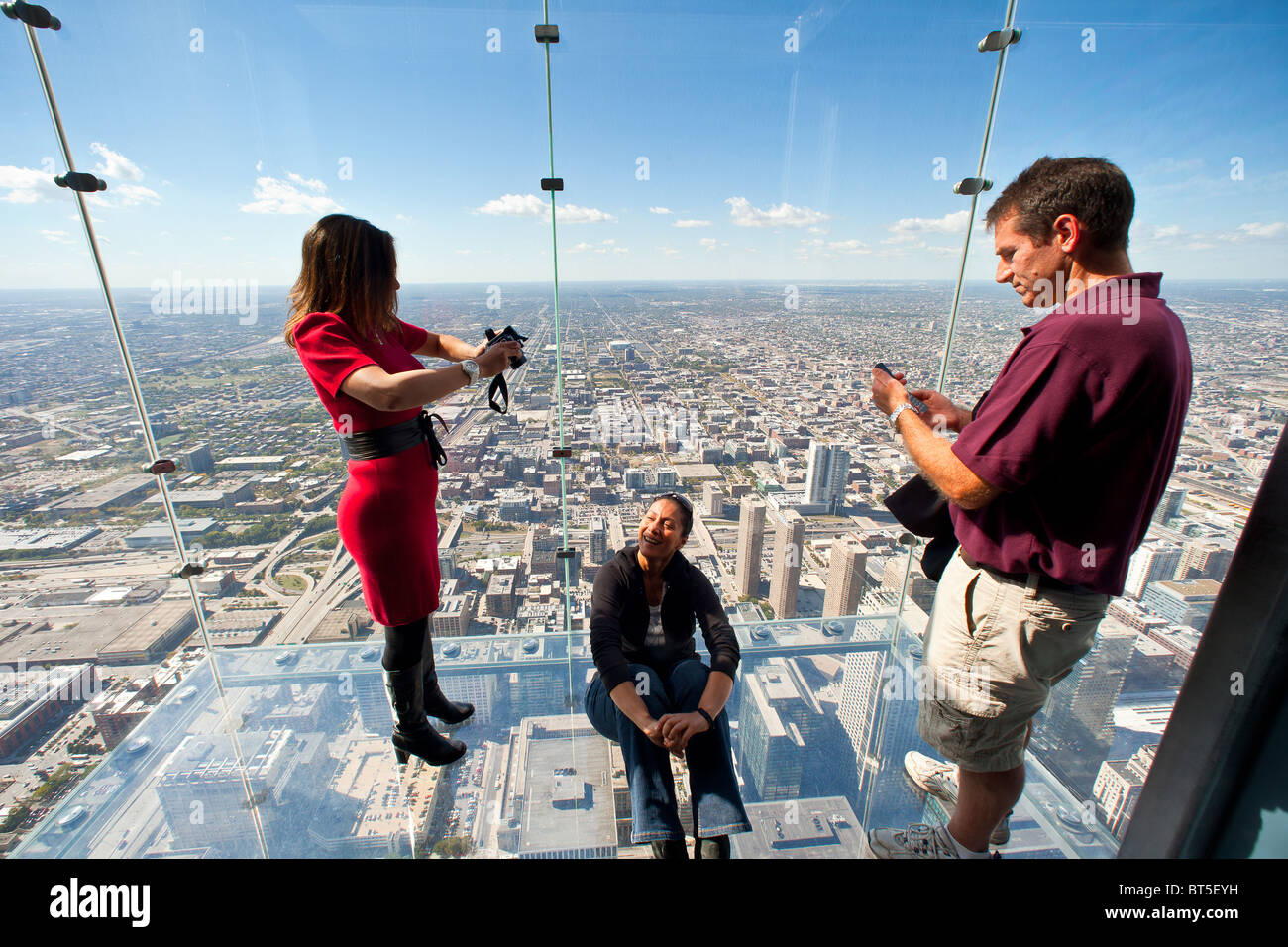 Tourists in glass balcony skydeck observation deck view Chicago skyline103rd floor of the Willis Tower Sears Tower Stock Photo