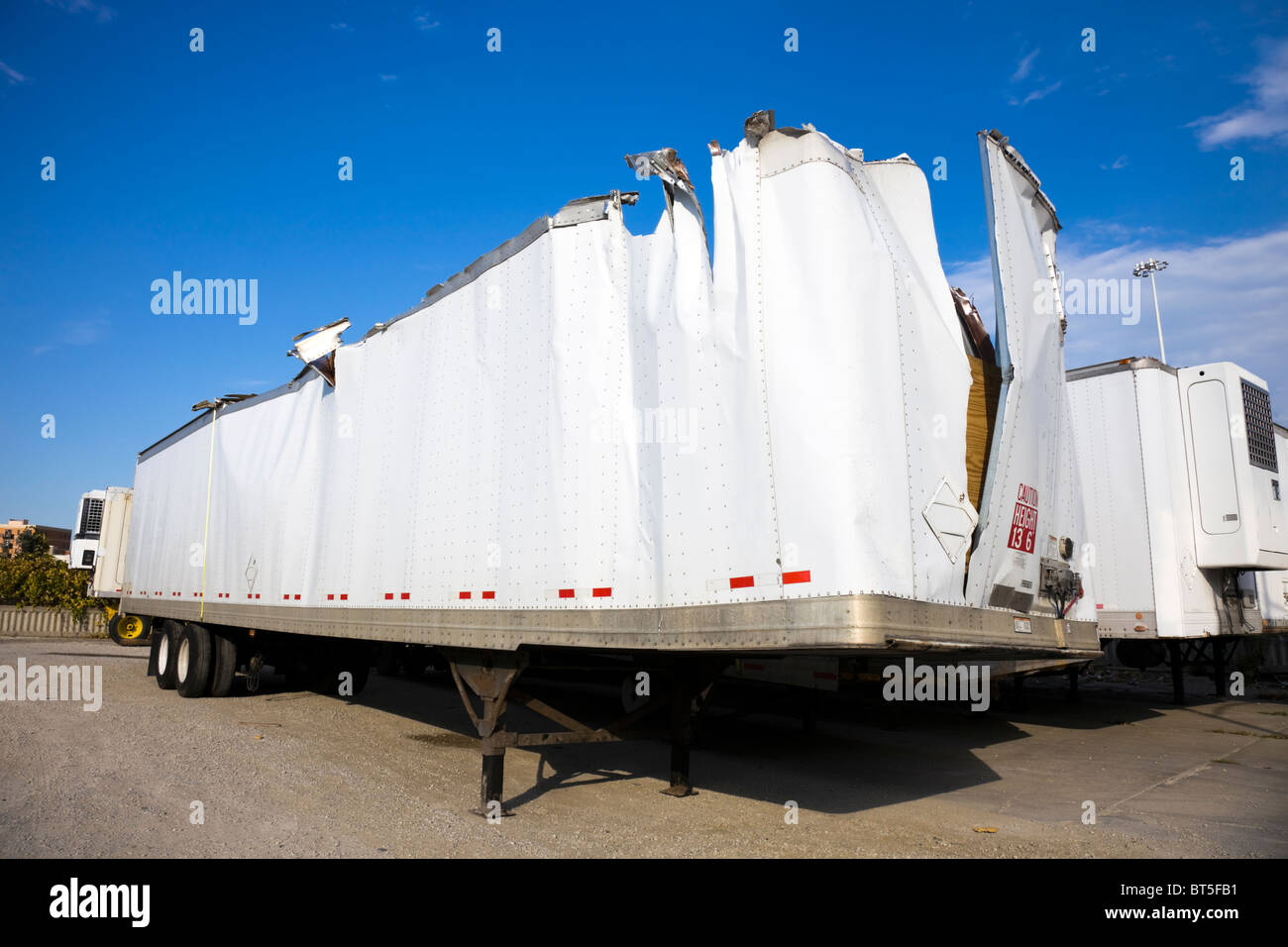 White trailer after accident against blue sky. Stock Photo