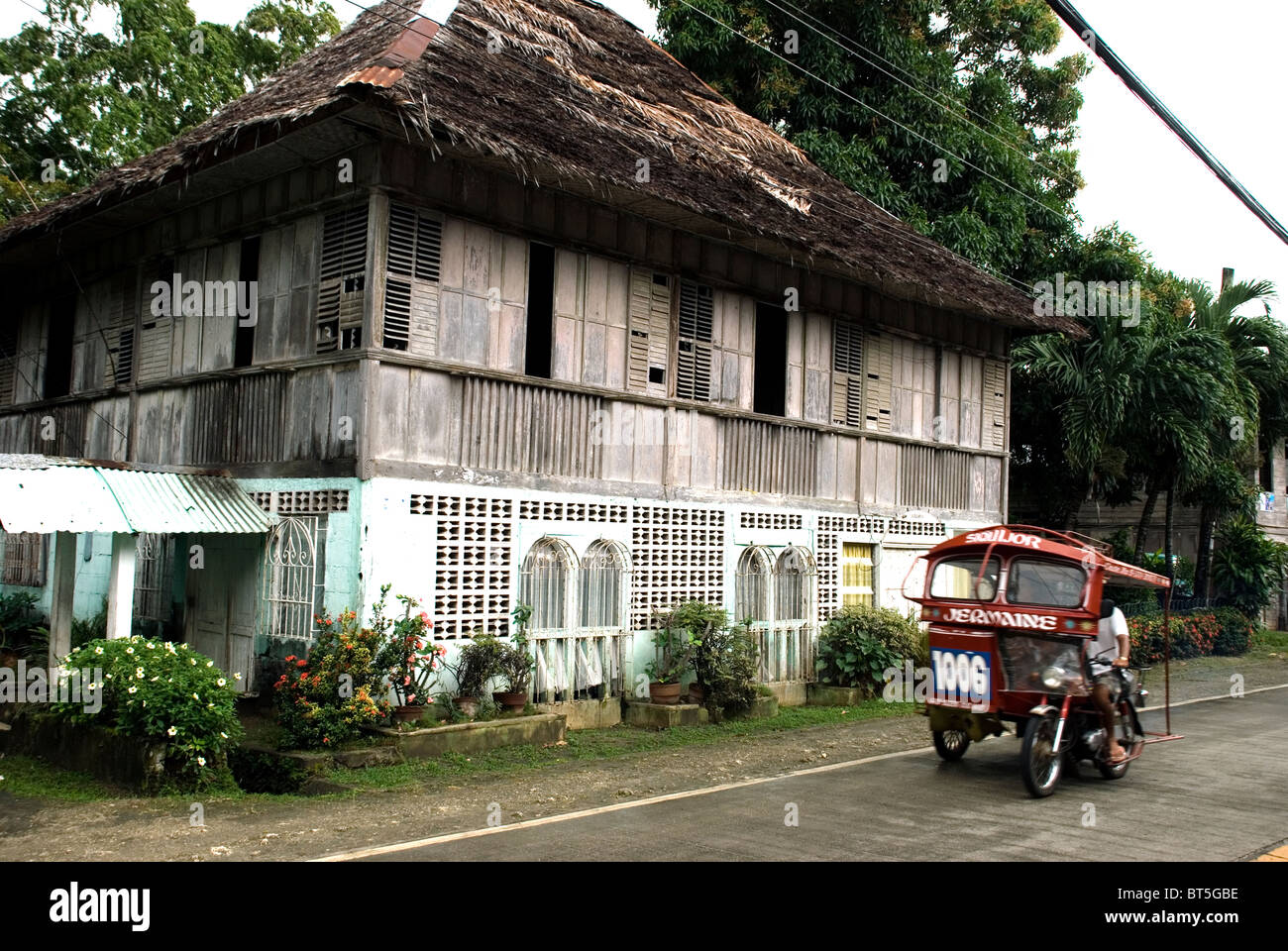 philippines, siquijor island, siquijor town, old timber house with tricycle Stock Photo